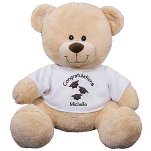 Graduation Teddy Bear Keepsake ? Personalized Graduation Teddy BearThis fun loving teddy bear creates a wonderful graduation keepsake that will be cherished year after year. Our Plush Graduation Teddy Bear is a wonderful gift to present any graduating class. This graduation design is featured on our Sherman Teddy Bear. Our Sherman Teddy Bear has an irresistible look on his face along with a wonderfully soft feel. He features contrasting tan fur on the inside of his ears and his snout. He measures about 21? and makes a wonderful gift for any graduation. Free Gift Wrapping and a Free Gift Card are included to create a thoughtful presentation. Personalize the t-shirt worn by this bear with any two line custom message.
